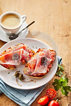 Gourmet tostada snacks with prosciutto ham photo