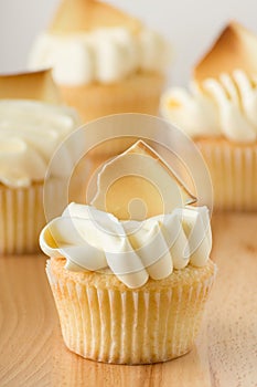Gourmet Vanilla Cupcakes With Buttercream Frosting And White Chocolate Garnish