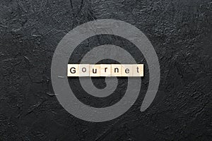 gourmet word written on wood block. gourmet text on cement table for your desing, concept