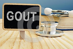 Gout disease. Book and stethoscope photo