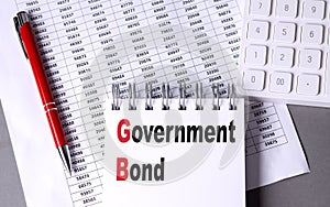 GOVERNMENT BOND text on notebook with chart , pen and calculator photo