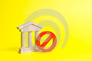 Government building or bank and symbol NO on an yellow background. The concept of prohibiting and restrictive laws. Bans photo
