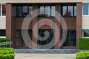 A government building with large glass windows and doors. Modern office building. Architecture and facade of the building