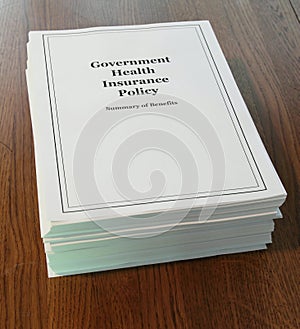 Government Health Insurance Policy on a desk.