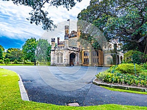 Government House of Sydney, Australia, surrounded by lush and vibrant greenery.