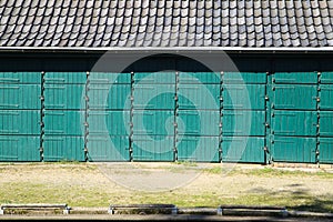 Government shutdown symbol concept: View on boathouse with boxes for canoes in a row locked with padlocks - Germany