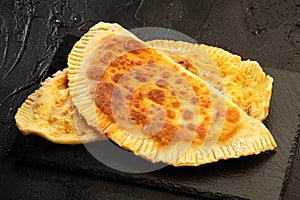 Gozleme savory Turkish stuffed flatbread with cheese on a stone board top view