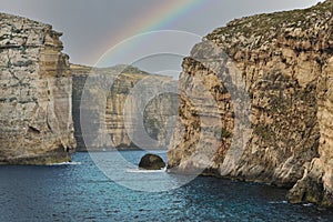 Gozo island cliffs, Malta seaside landscape with rainbow