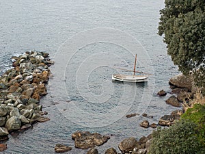 Gozzo boat  anchored in a quiet bay of the Ligurian Riviera