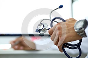 GP holding in hand stethoscope