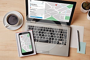 GPS map navigation app on laptop and smartphone screen. Location