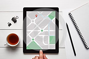 GPS map navigation app on tablet screen. Location tracker concept