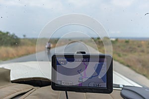 GPS placed on car glass to indicate the way by africa. Angola.