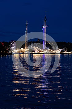 Reflections at night of the amusement park GrÃ¶na Lund in Stockholm, Sweden photo