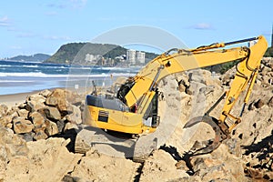 Grab excavator. Boulder wall construction.