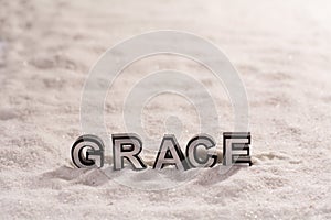 Grace word on white sand