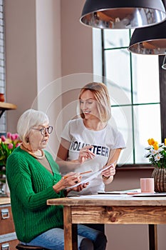 Graceful aging woman looking surprisingly at document form