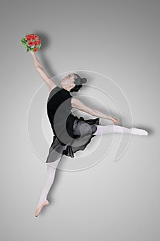 Graceful ballerina is dancing with flowers