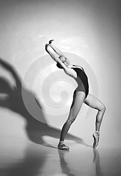 Graceful ballerina dancing in a studio