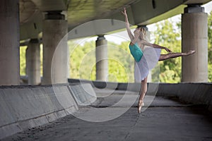 Graceful ballerina doing dance exercises on a