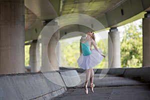 Graceful ballerina doing dance exercises on a