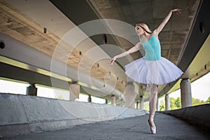 Graceful ballerina doing dance exercises on a