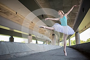 Graceful ballerina doing dance exercises on a