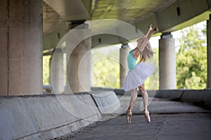 Graceful ballerina doing dance exercises on a