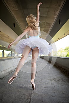 Graceful ballerina doing dance exercises on a
