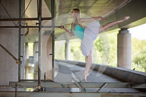 Graceful ballerina doing dance exercises on a