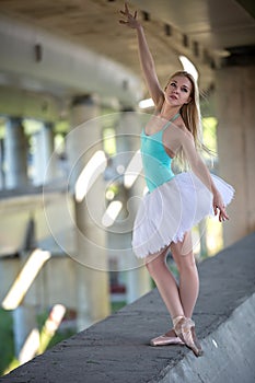 Graceful ballerina in the industrial background