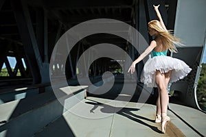 Graceful ballerina in the industrial background