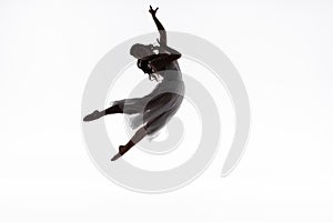 Graceful ballerina jumping while dancing isolated on white