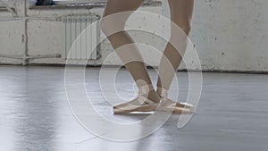 Graceful ballerina legs in pointe shoes. girl dancing in the old dance hall slow motion