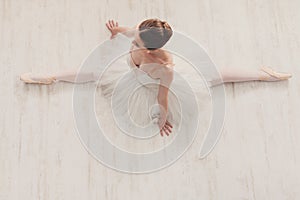 Graceful ballerina stretching, ballet background