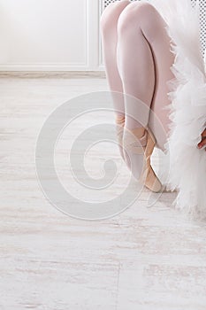 Graceful ballerina stretching, ballet background