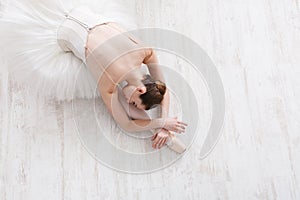 Graceful ballerina stretching, ballet background