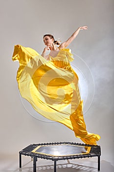 graceful charming woman with yellow Flying Fluttering Fabric