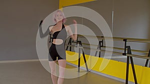 Graceful energetic hip hop woman dancer performing freestyle dance in studio.