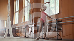 Graceful girl ballerina practicing in the Studio, elements of dance