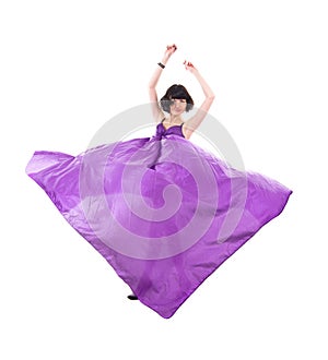 Graceful girl in flying purple silk fabric