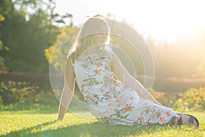 Graceful girl happily posing while walking in the park.