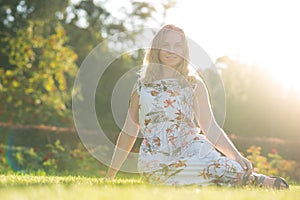 Graceful girl happily posing while walking in the park.