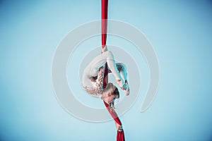 Graceful gymnast performing aerial exercise