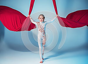 Graceful gymnast performing aerial exercise