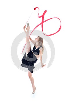 Graceful gymnast with ribbon stands on one leg