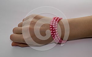 A graceful pink bracelet on a woman`s hand. photo