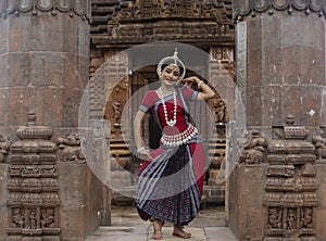 Graceful pose of a Classical odissi or orissi dancer at Mukteshvara Temple,Bhubaneswar, Odisha, India