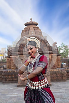 Graceful Pose of Odissi dancer posing in front of Mukteshvara temple.