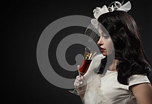 Graceful woman holding glass of wine